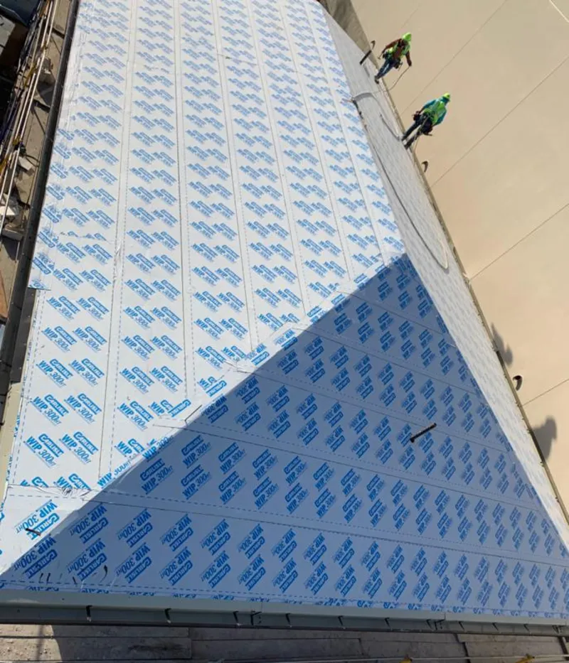 Professional roofers installing underlayment on a metal roof in Havre de Grace